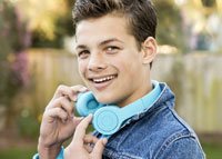 Młody chłopak z niebieskimi słuchawkami na szyi